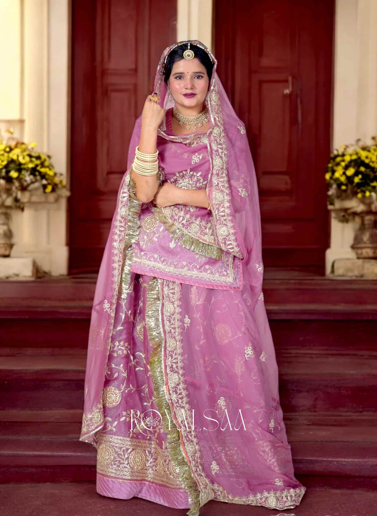 Woman wearing peach-pink Rajputi Poshak with golden gota patti embroidery, styled with traditional jewelry – Royalsaa ethnic collection