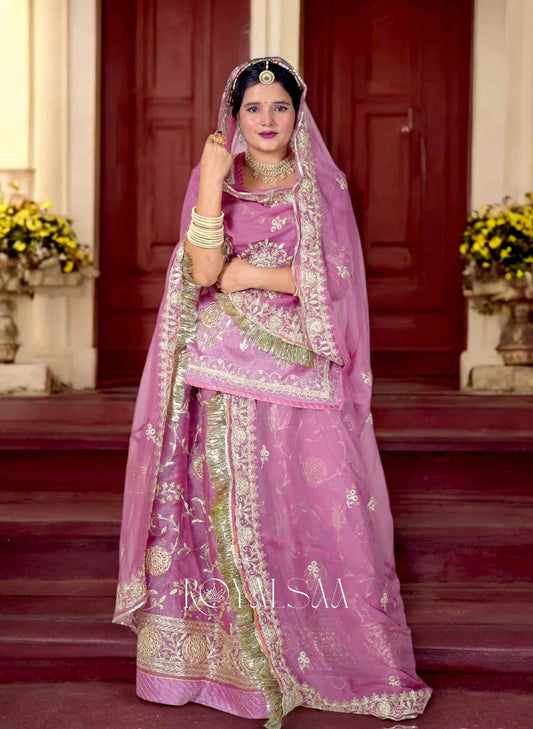 Woman wearing peach-pink Rajputi Poshak with golden gota patti embroidery, styled with traditional jewelry – Royalsaa ethnic collection
