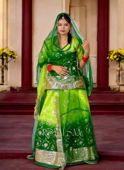 Woman wearing green Rajputi Poshak with silver gota patti work and traditional jewelry – Royalsaa festive ethnic wear